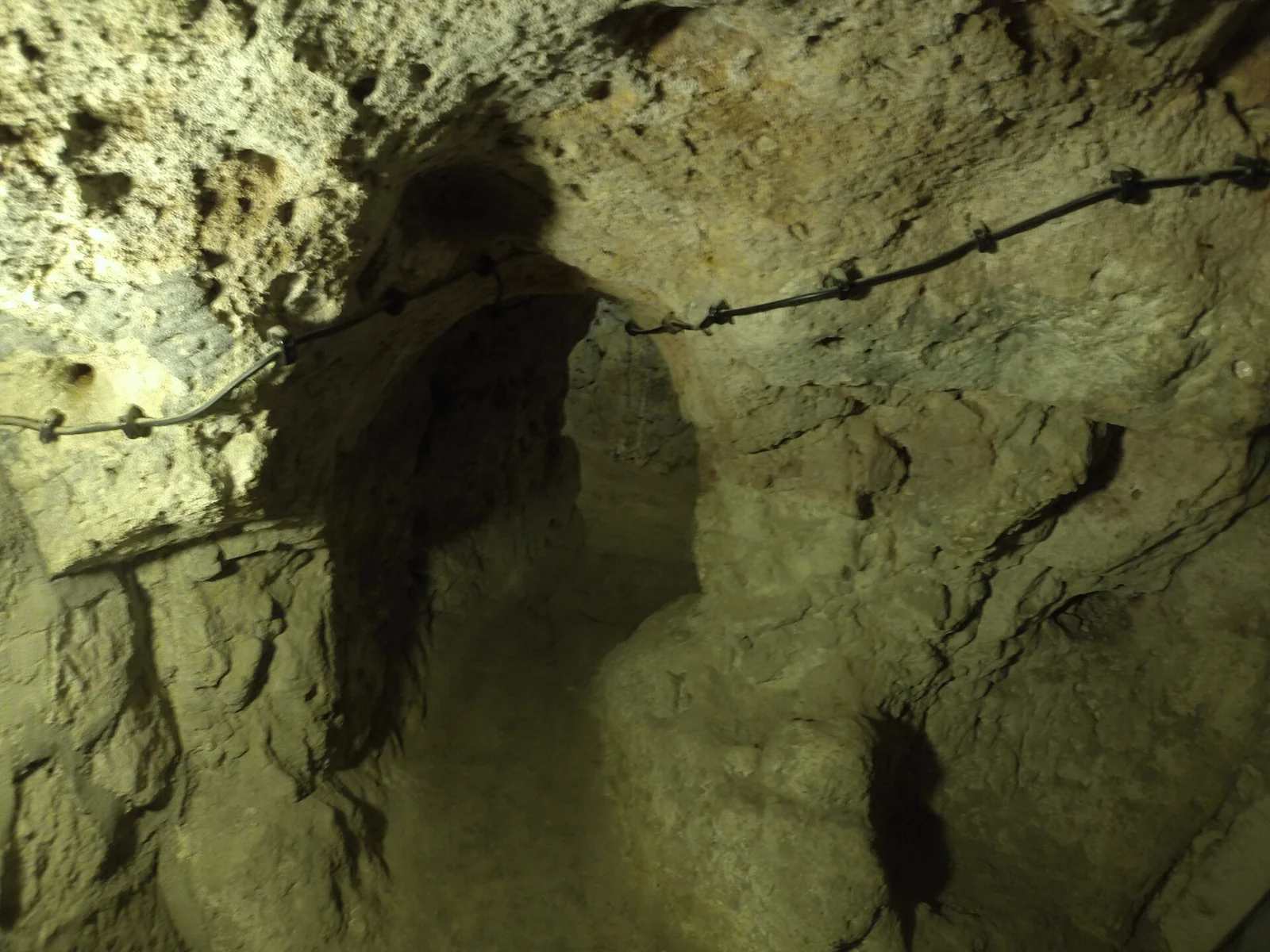 Rock-cut wall and narrow opening within Derinkuyu