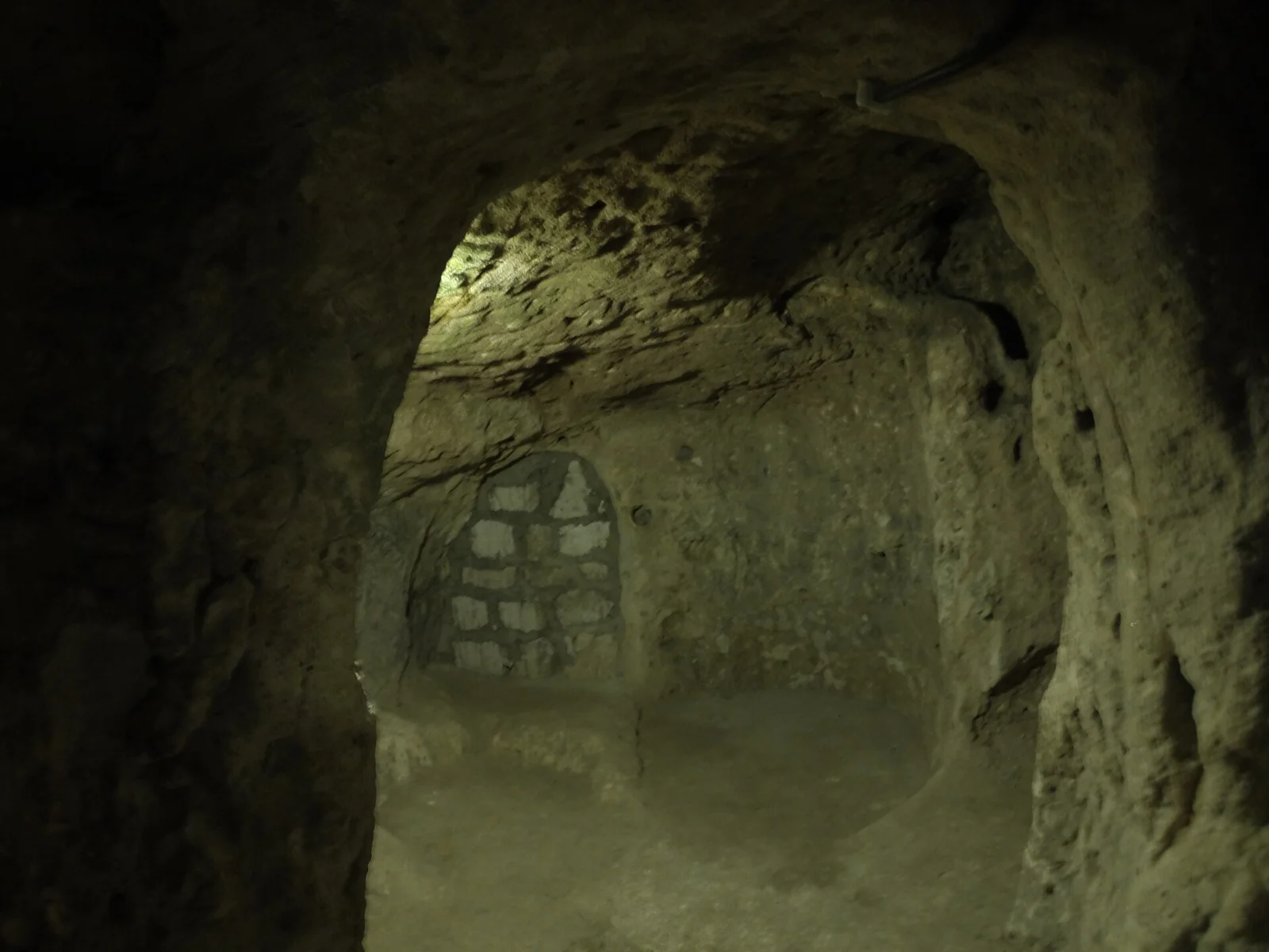 Carved rock walls and a masonry addition inside Derinkuyu