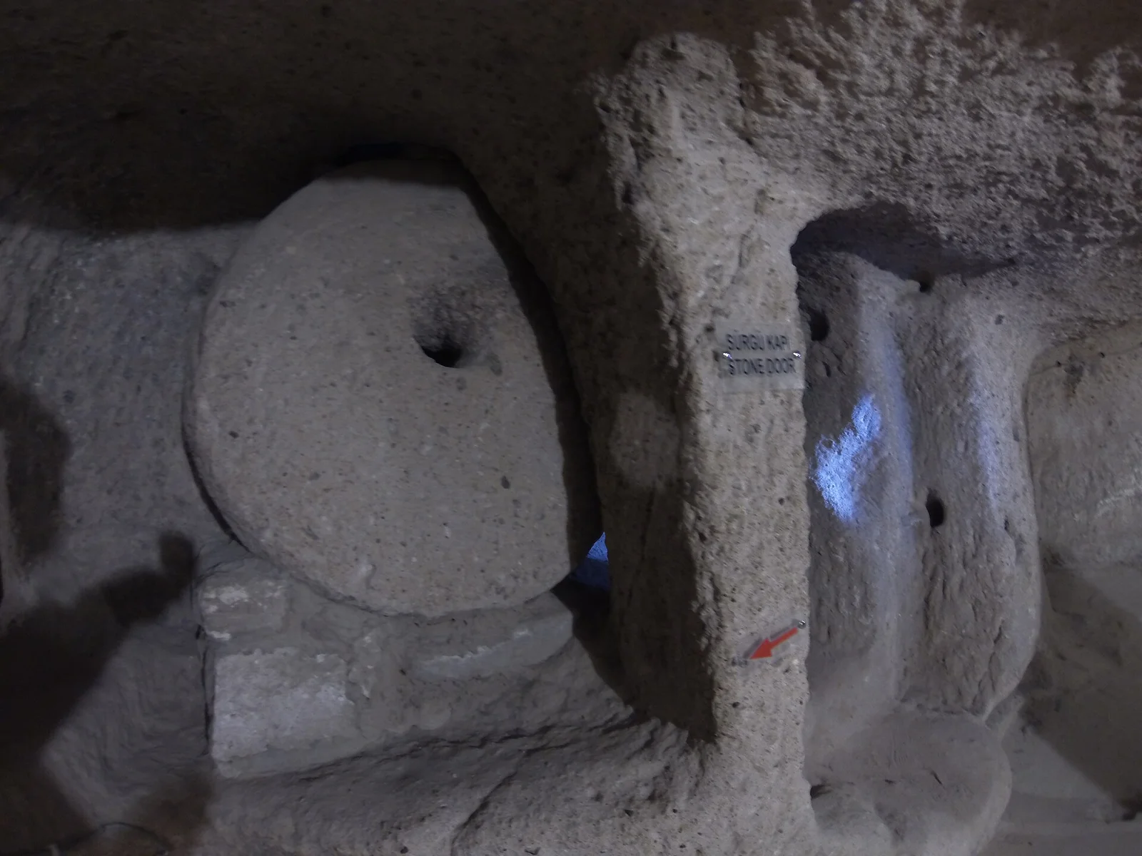 Stone barrier and carved opening at Kaymakli Underground City
